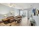 Open living room with tile flooring, comfortable leather furniture, and neutral paint at 1892 San Silvestro Dr, Venice, FL 34285