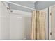 Shower with white tile surround and a patterned shower curtain at 1892 San Silvestro Dr, Venice, FL 34285