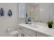 Well-lit bathroom featuring a modern vanity, sleek fixtures, and a glass-enclosed shower at 19337 Cruise Dr, Venice, FL 34292