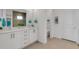 Modern bathroom with double vanity, white cabinets, and a separate toilet room at 19337 Cruise Dr, Venice, FL 34292