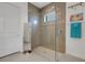 Modern bathroom with glass-enclosed shower featuring a rainfall showerhead and light tile at 19337 Cruise Dr, Venice, FL 34292