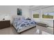 Bright bedroom features white walls, tile floors, and a stylish bed with a unique fish-themed comforter set at 19337 Cruise Dr, Venice, FL 34292