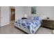 Bright bedroom features white walls, tile floors, and a stylish bed with a unique fish-themed comforter set at 19337 Cruise Dr, Venice, FL 34292