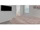 Bedroom featuring TV, neutral walls, view into the bathroom, and a pink bedspread at 19337 Cruise Dr, Venice, FL 34292