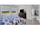 Bright bedroom with large windows offering serene water views and a dark wood dresser at 19337 Cruise Dr, Venice, FL 34292