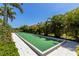 Bocce ball court surrounded by lush landscaping offering recreational opportunities for residents at 19337 Cruise Dr, Venice, FL 34292