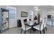 Dining area with a sleek table, white chairs, modern décor, and bright, natural light at 19337 Cruise Dr, Venice, FL 34292