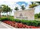 Elegant community entrance sign surrounded by lush landscaping and vibrant flowers at 19337 Cruise Dr, Venice, FL 34292