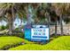 Inviting Venice Beach entrance sign surrounded by lush tropical landscaping and palm trees at 19337 Cruise Dr, Venice, FL 34292