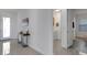 Bright entryway with tile floors, modern console table and views of the laundry and bedroom at 19337 Cruise Dr, Venice, FL 34292