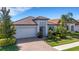 Beautiful home with a well-manicured lawn and lush landscaping under a sunny sky at 19337 Cruise Dr, Venice, FL 34292