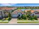 Charming home with a well-manicured lawn, brick driveway, and beautiful landscaping at 19337 Cruise Dr, Venice, FL 34292