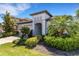 Beautiful home featuring lush landscaping, a tile roof, and an inviting entryway at 19337 Cruise Dr, Venice, FL 34292
