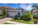 Charming home with lush landscaping, brick driveway, and a welcoming facade at 19337 Cruise Dr, Venice, FL 34292