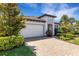 Well-maintained home with a spacious two-car garage, paved driveway, and lush landscaping at 19337 Cruise Dr, Venice, FL 34292