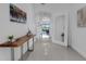Bright hallway with neutral walls, recessed lighting, and modern decor that leads to living area at 19337 Cruise Dr, Venice, FL 34292