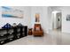 Bright hallway with a comfortable chair and decorative wall art at 19337 Cruise Dr, Venice, FL 34292