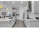 Open kitchen with white cabinets, a large island, stainless steel appliances, and access to other living areas at 19337 Cruise Dr, Venice, FL 34292