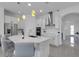 Bright kitchen with white cabinetry, stainless steel appliances, and a large center island with bar seating at 19337 Cruise Dr, Venice, FL 34292
