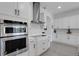 Modern kitchen features stainless steel appliances, white cabinetry, backsplash, and a gas cooktop at 19337 Cruise Dr, Venice, FL 34292