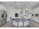 Bright modern kitchen with quartz counters, pendant lighting, and a stainless steel refrigerator at 19337 Cruise Dr, Venice, FL 34292