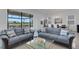 Bright living room featuring stylish furnishings and expansive windows with lake views at 19337 Cruise Dr, Venice, FL 34292