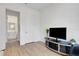 Cozy living room with light wood floors and modern entertainment center at 19337 Cruise Dr, Venice, FL 34292