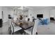 Spacious layout featuring a modern dining area, kitchen, and living room with elegant furnishings at 19337 Cruise Dr, Venice, FL 34292
