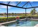 Screened-in pool with water feature and serene lake views, creating a private oasis at 19337 Cruise Dr, Venice, FL 34292