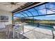 Covered patio with dining table overlooking pool and lake at 19337 Cruise Dr, Venice, FL 34292