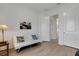 Cozy room featuring a futon, wood floors, and neutral walls, creating a peaceful space at 19337 Cruise Dr, Venice, FL 34292