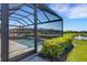 Screened-in lanai with outdoor seating and a swimming pool, overlooking a peaceful lake view at 19337 Cruise Dr, Venice, FL 34292