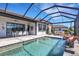 Screened-in lanai features a swimming pool, dining table and chairs and outdoor seating at 19337 Cruise Dr, Venice, FL 34292