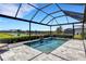 Screened-in lanai features a swimming pool with a fountain and a view of the lake at 19337 Cruise Dr, Venice, FL 34292