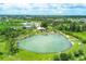 Gorgeous aerial view of Warm Mineral Springs and surrounding trees and neighborhood at 2032 Jagust Rd, North Port, FL 34288