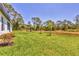 Spacious backyard featuring lush green grass and a charming outdoor seating area at 2032 Jagust Rd, North Port, FL 34288