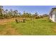 Large grassy backyard with seating area, perfect for outdoor gatherings and relaxation at 2032 Jagust Rd, North Port, FL 34288