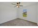 Empty bedroom with carpet, ceiling fan, and a bright window view at 2032 Jagust Rd, North Port, FL 34288