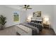 Staged bedroom features a window with a view, ceiling fan, and coordinated furniture at 2032 Jagust Rd, North Port, FL 34288