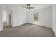 Vacant bedroom with neutral carpet, ceiling fan, and bright window light at 2032 Jagust Rd, North Port, FL 34288