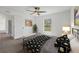 Staged bedroom with a ceiling fan, window view, and thoughtfully decorated furniture at 2032 Jagust Rd, North Port, FL 34288
