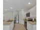 Well-lit kitchen featuring stainless steel appliances, sleek countertops, and abundant storage space at 2032 Jagust Rd, North Port, FL 34288