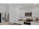 Bright kitchen featuring stainless steel appliances, sleek countertops, and ample storage at 2032 Jagust Rd, North Port, FL 34288