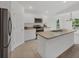 Modern kitchen boasts stainless steel appliances, a functional island, and an abundance of cabinet space at 2032 Jagust Rd, North Port, FL 34288