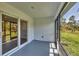 A screened lanai has sliding glass doors to the interior and a beautiful view to the rear at 2032 Jagust Rd, North Port, FL 34288