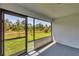 Screened lanai overlooking the green space provides a serene outdoor living area at 2032 Jagust Rd, North Port, FL 34288