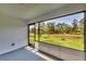 Screened lanai with a view of the backyard and green space at 2032 Jagust Rd, North Port, FL 34288