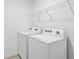 A view of the laundry room with a washer and dryer, and overhead wire shelving at 2032 Jagust Rd, North Port, FL 34288