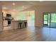 Open-concept living space with modern kitchen, dining area, and sliding glass doors to patio at 2032 Jagust Rd, North Port, FL 34288