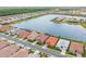 Aerial view of homes in a lakeside community with manicured lawns, community lakes and verdant scenery at 20660 Ovid Ln, Venice, FL 34293